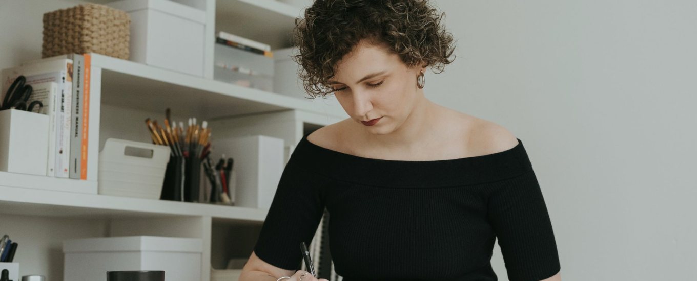 An editor marking up a draft at a desk